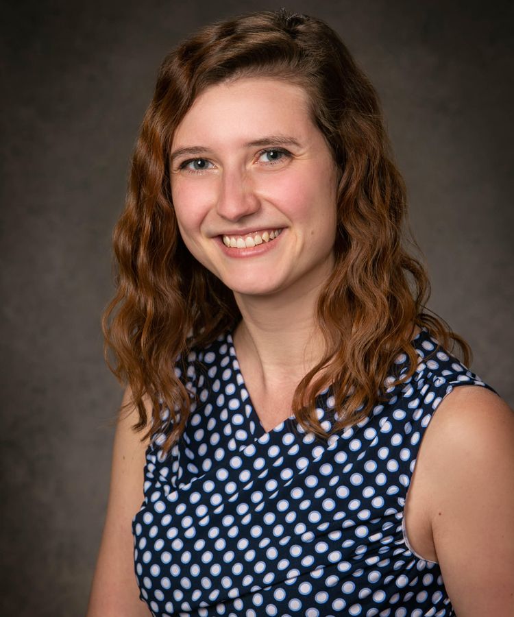 smiling woman blue polkadots Dr. Tori Brua